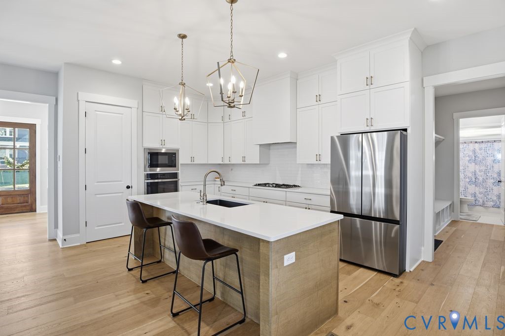 3818 Bellstone Drive Midlothian, VA 23112 - Photo 8 of 35 a kitchen with stainless steel appliances granite countertop a refrigerator a sink dishwasher a stove and a refrigerator with wooden floor