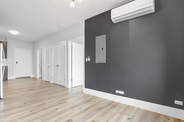 a view of an empty room with wooden floor