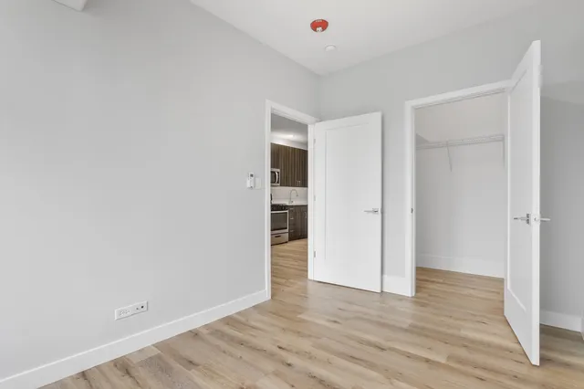 a view of an empty room with wooden floor