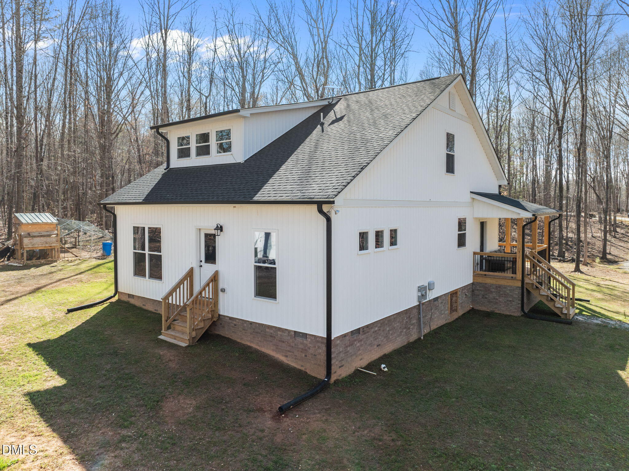 8514 Charlie Stovall Road Roxboro, NC 27574 - Photo 8 of 48 a view of a white house with a yard and sitting area