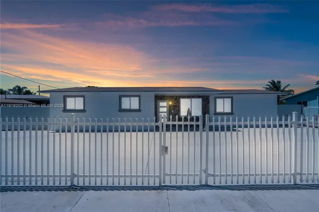 a front view of a house with a fence
