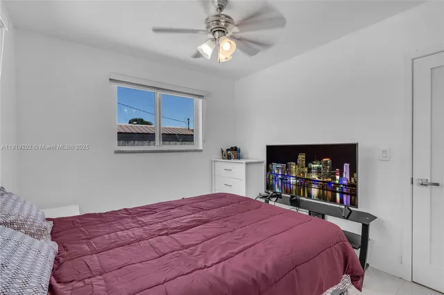 a bedroom with a large bed and a bookshelf