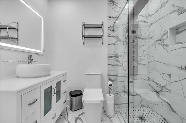 a bathroom with a sink toilet and shower