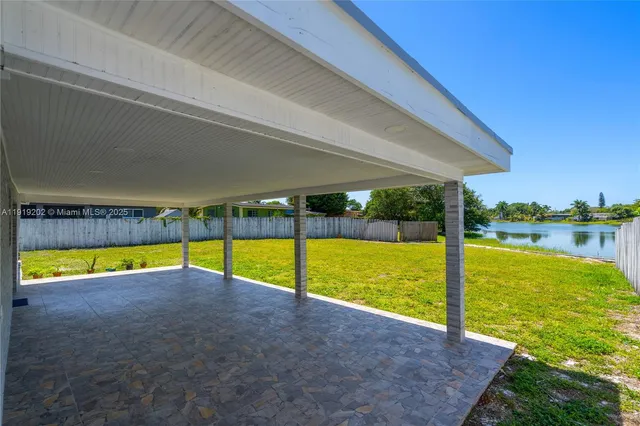 a view of a swimming pool with an outdoor seating and a yard