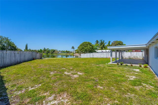 a view of a swimming pool with a yard