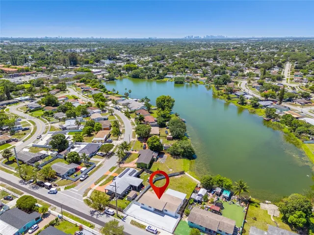 an aerial view of residential building and lake