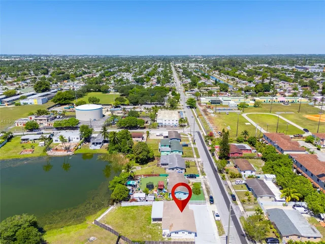 an aerial view of residential building and lake