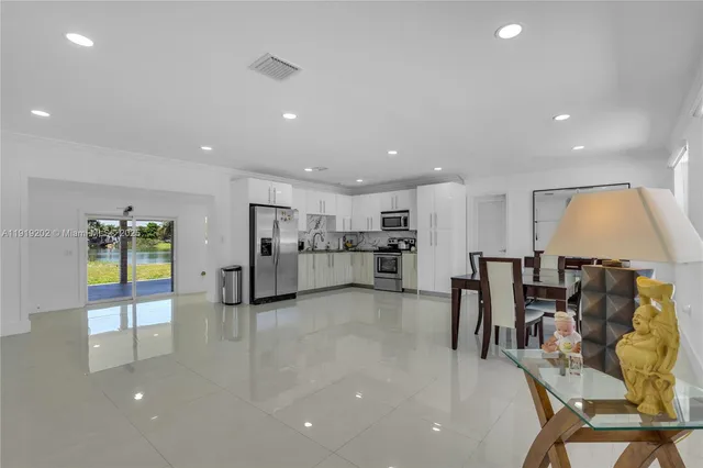 a view of kitchen with kitchen island dining table and chairs
