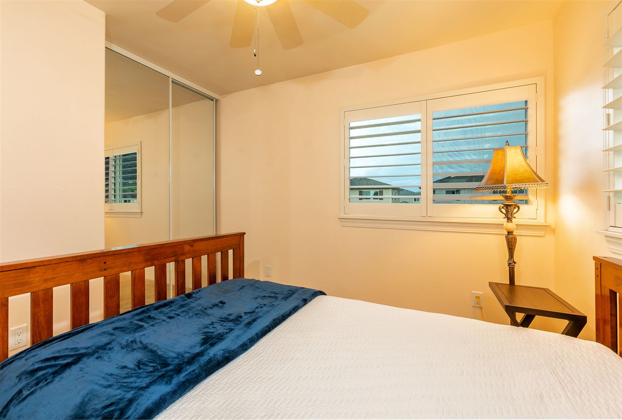 209 Alake Street Kahului, HI 96732 - Photo 11 of 30 a bedroom with a bed and wooden floor