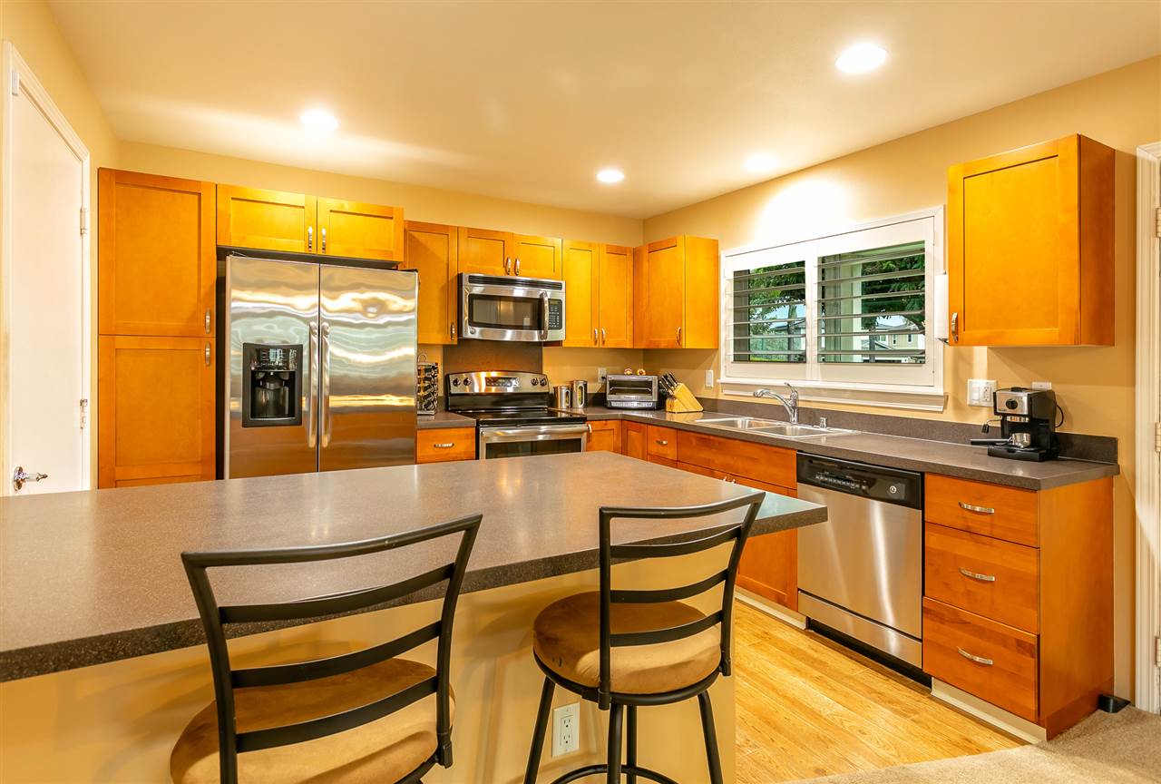 209 Alake Street Kahului, HI 96732 - Photo 2 of 30 a kitchen with stainless steel appliances granite countertop a stove a sink and a refrigerator