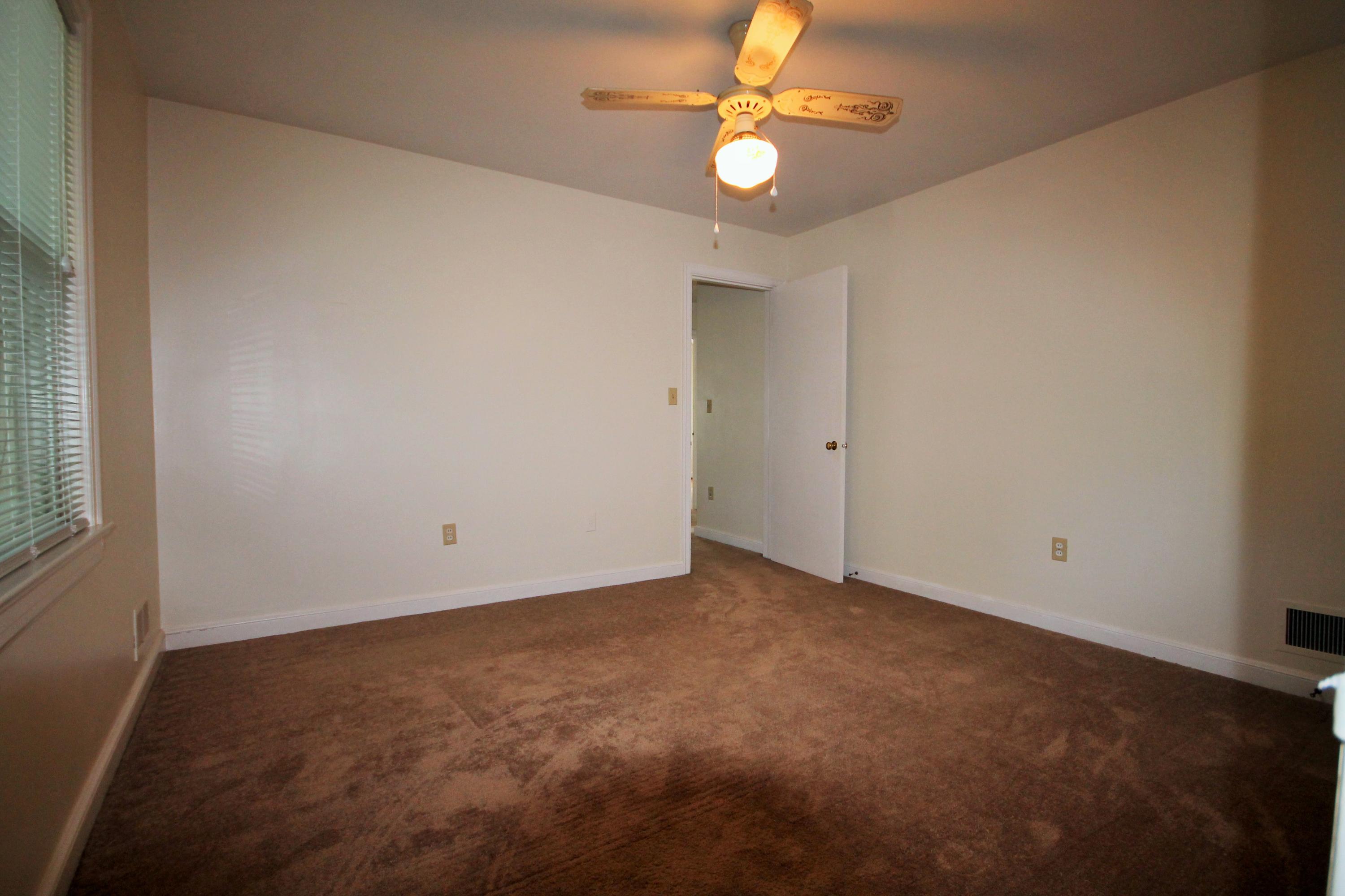 2364 Howard Road Southwest Roanoke, VA 24015 - Photo 11 of 17 an empty room with a chandelier fan and windows