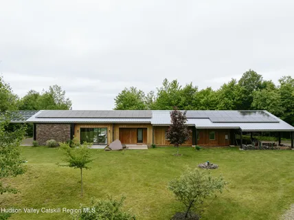 a view of a house with backyard porch and sitting area