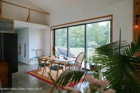 a living room with furniture a fireplace and a chandelier