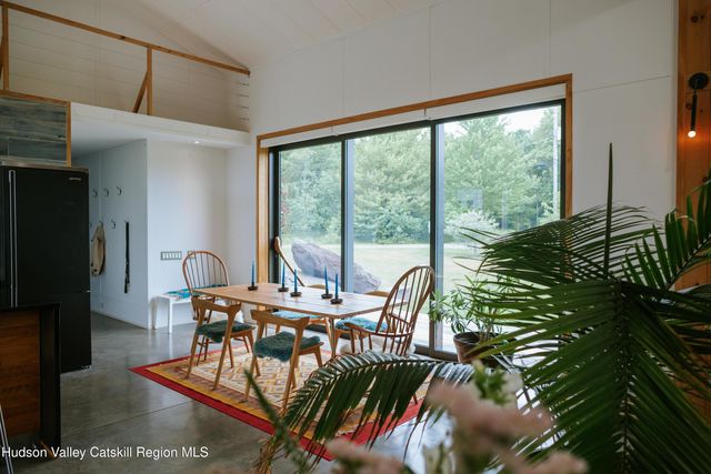 a living room with furniture a fireplace and a chandelier