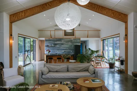 a brick building with a bench and a potted plant