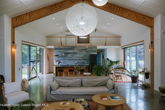 a brick building with a bench and a potted plant