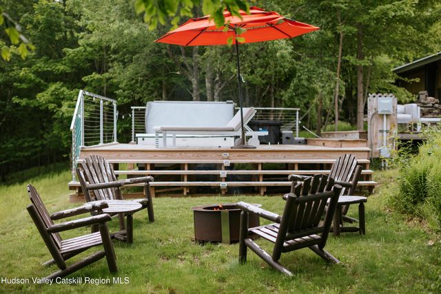 a roof deck with table and chairs under an umbrella