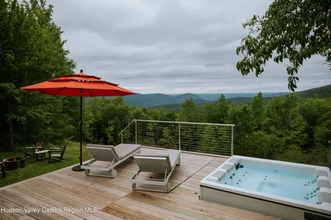 a view of a chair and table on the green field