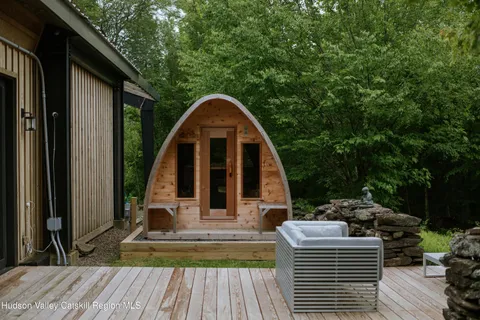 a bed sitting in a bedroom next to a window