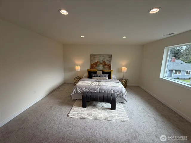 a bedroom with a bed and a painting on the wall