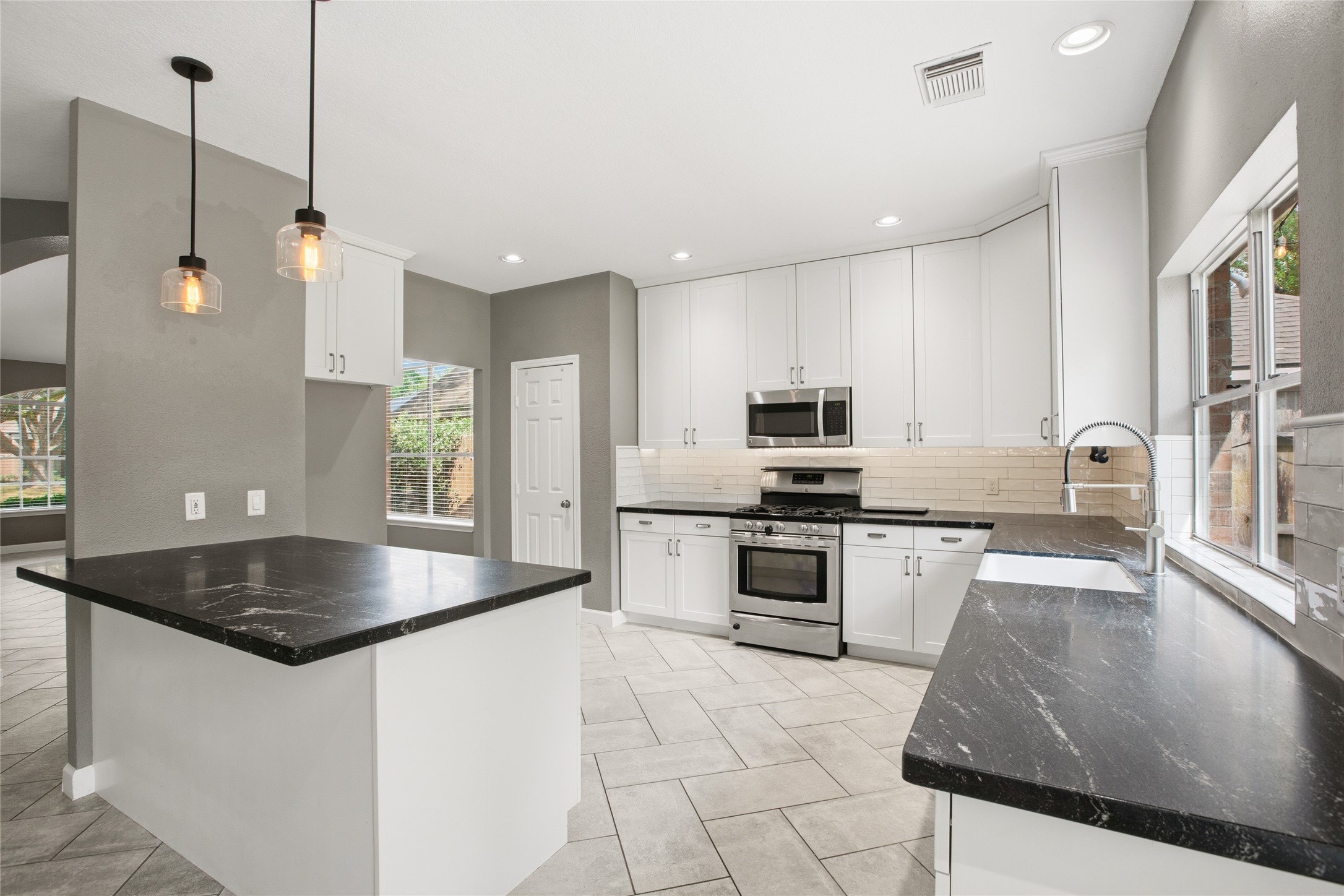 20907 Nettlebrook Lane Katy, TX 77450 - Photo 13 of 46 Granite countertops, stainless steel appliances and ample custom cabinetry keep things practical without sacrificing style.