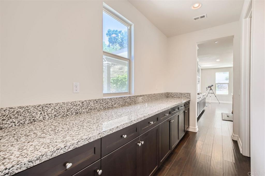 431 Machado Way Vista, CA 92083 - Photo 11 of 36 a view of a kitchen counter space a sink wooden floor and a window
