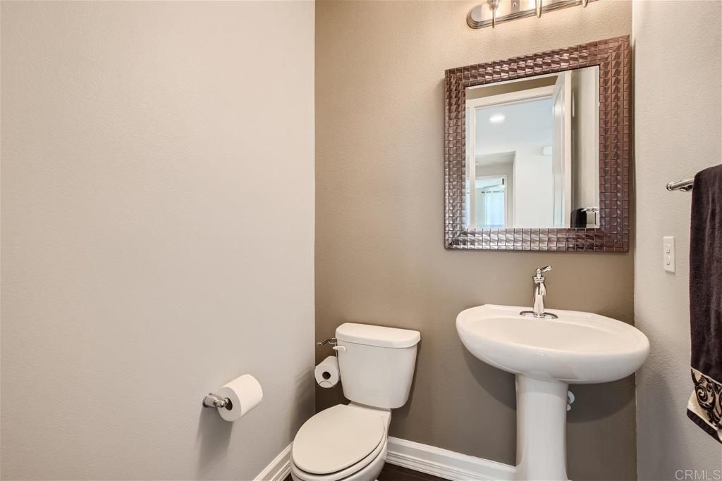 431 Machado Way Vista, CA 92083 - Photo 16 of 36 a bathroom with a toilet sink and mirror