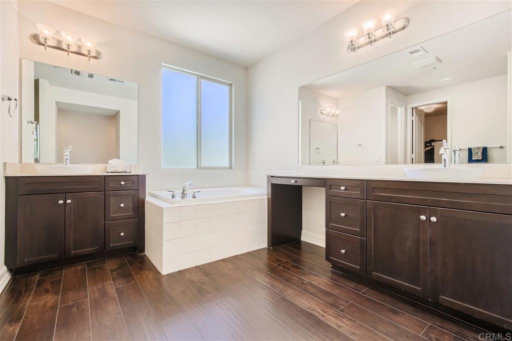 431 Machado Way Vista, CA 92083 - Photo 18 of 36 a spacious bathroom with a granite countertop sink mirror and a