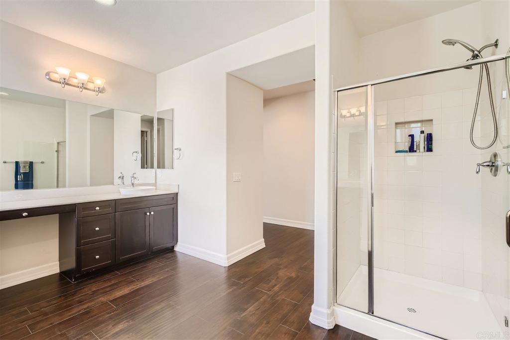431 Machado Way Vista, CA 92083 - Photo 19 of 36 a spacious bathroom with a shower sink and mirror