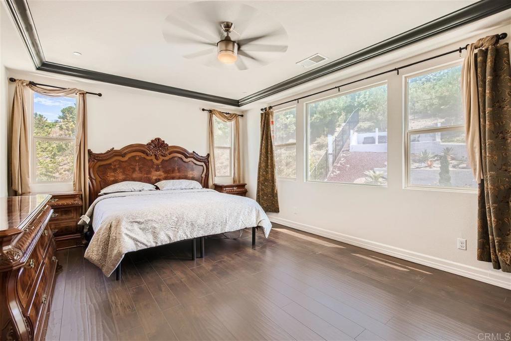 431 Machado Way Vista, CA 92083 - Photo 21 of 36 a bedroom with a large bed and a large window