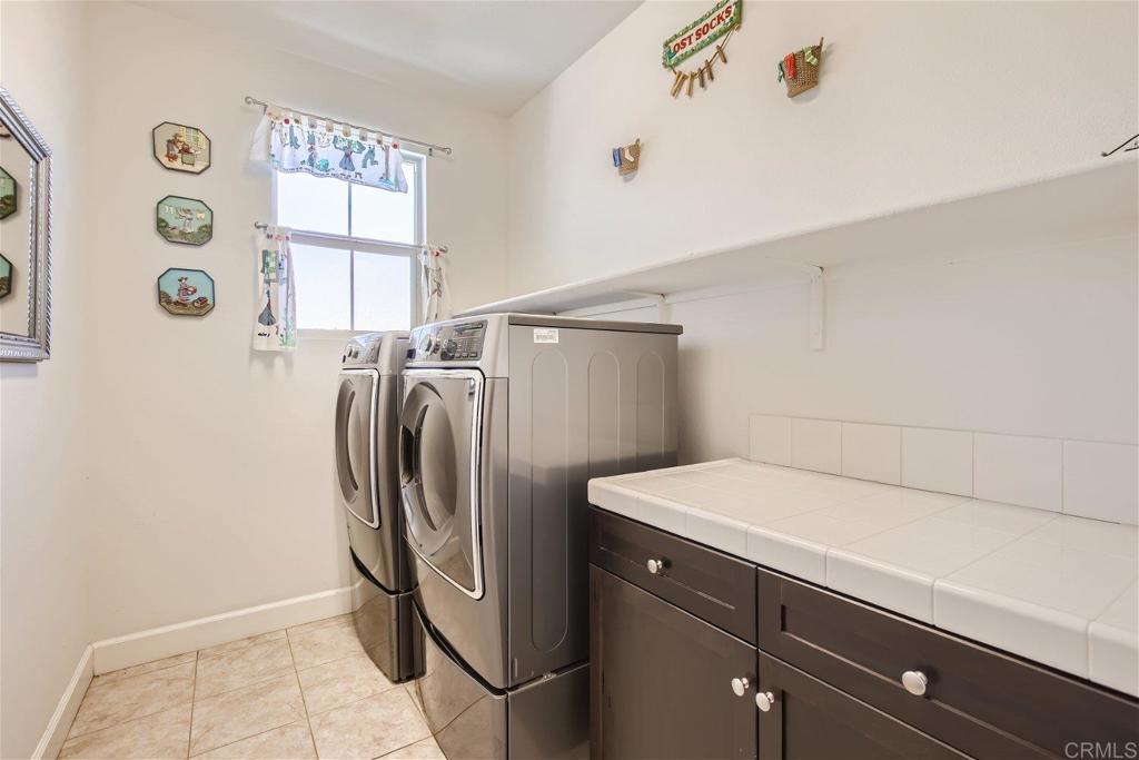 431 Machado Way Vista, CA 92083 - Photo 26 of 36 a utility room with dryer and washer