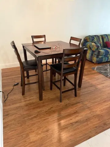 a view of a dining room with furniture and wooden floor