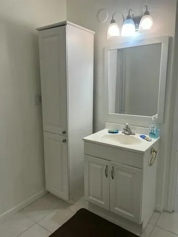 a bathroom with a sink and mirror