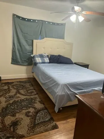 a bedroom with a bed and window