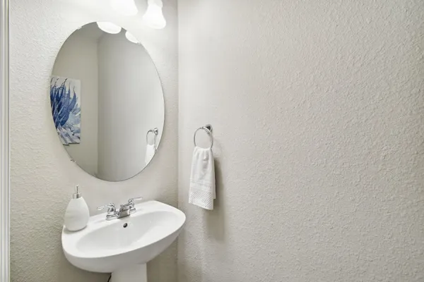 a kitchen with stainless steel appliances granite countertop a table chairs stove and refrigerator