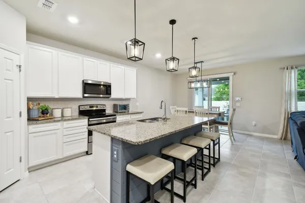 a kitchen with a center island and stainless steel appliances