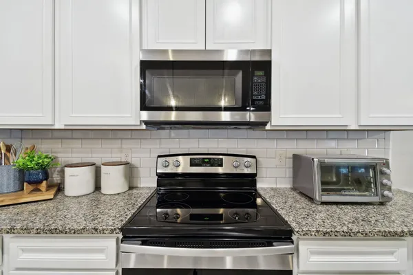 a view of living room with granite countertop living room with fireplace furniture and windows