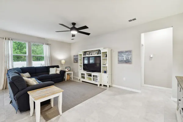 a bedroom with a bed and a dresser with wooden floor