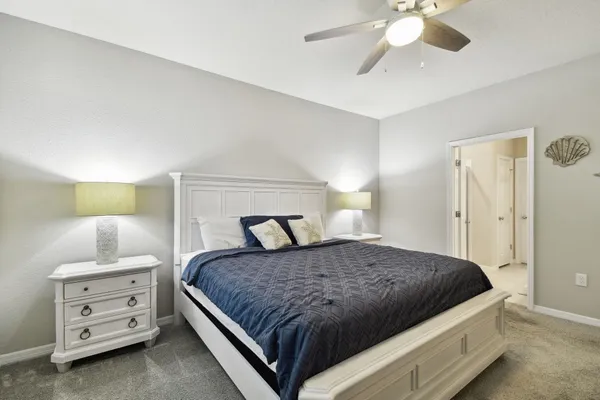 a bathroom with a granite countertop double vanity sink a mirror and a shower