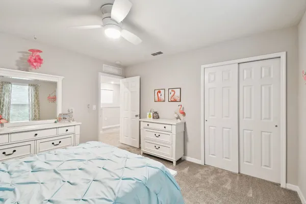 a large bedroom with a bed and a chandelier