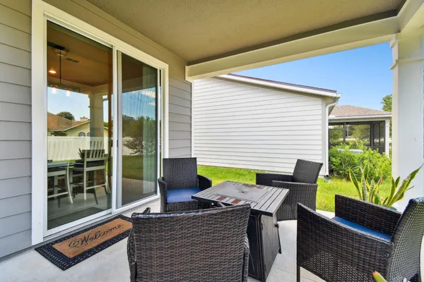 an aerial view of residential houses with outdoor space and ocean view