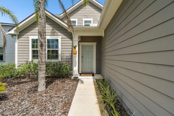 a view of a house with a white door and wooden floor