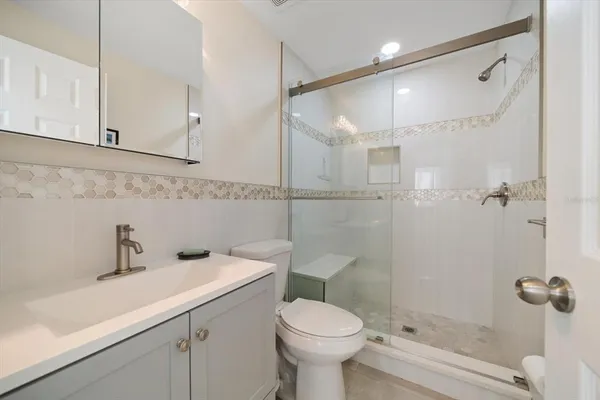 a bathroom with a toilet sink and shower