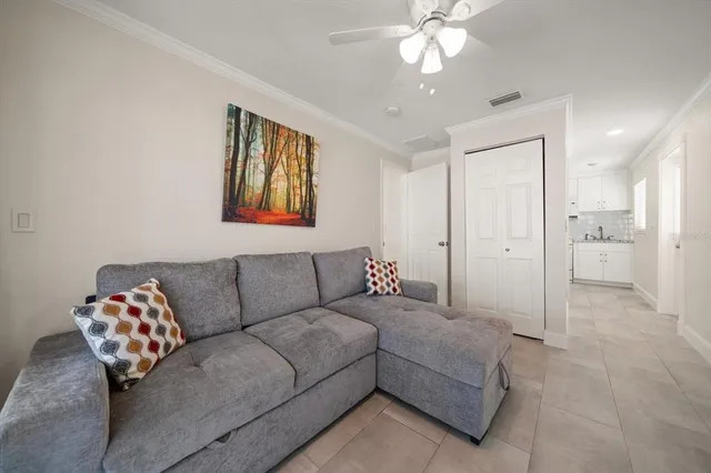 a bedroom with a bed and ceiling fan
