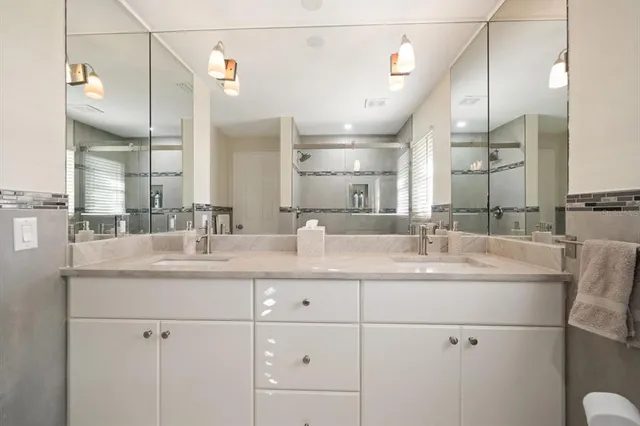 an aerial view of ocean and residential houses with outdoor space