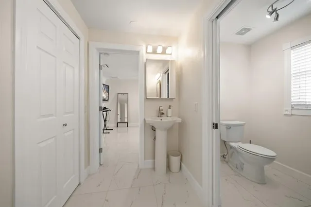 a dining room with furniture and a floor to ceiling window