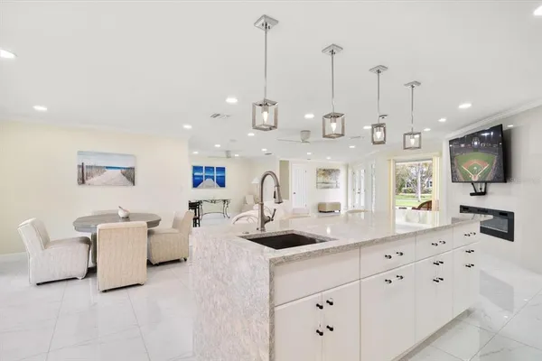 a spacious bedroom with a bed and a chandelier