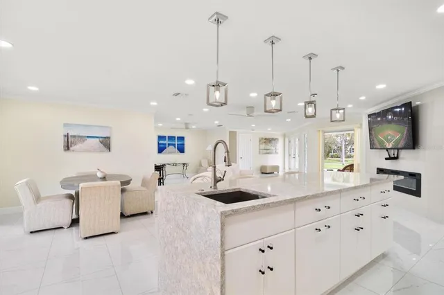 a spacious bedroom with a bed and a chandelier