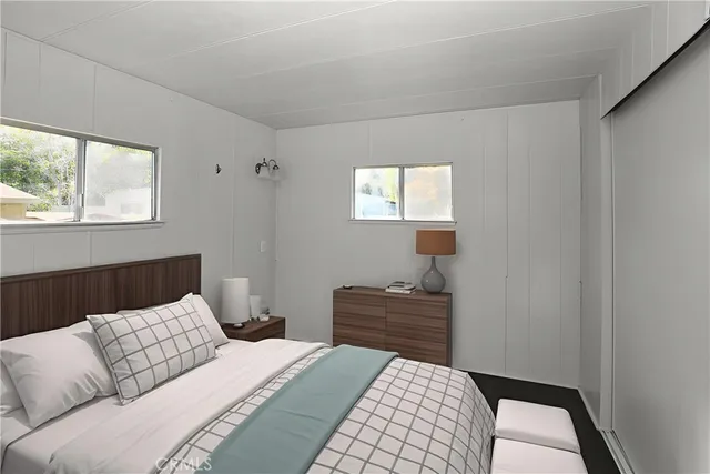 a bedroom with a bed and window