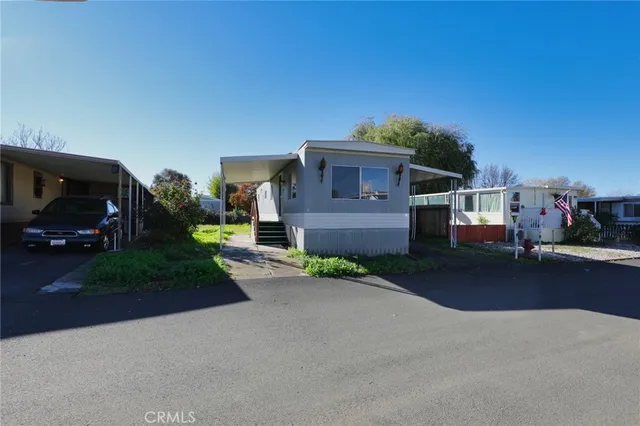 a view of a street with a cars parked in front of it